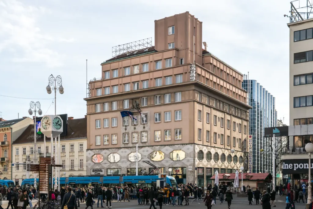 a tram passes a brutalist building in zagreb croatia