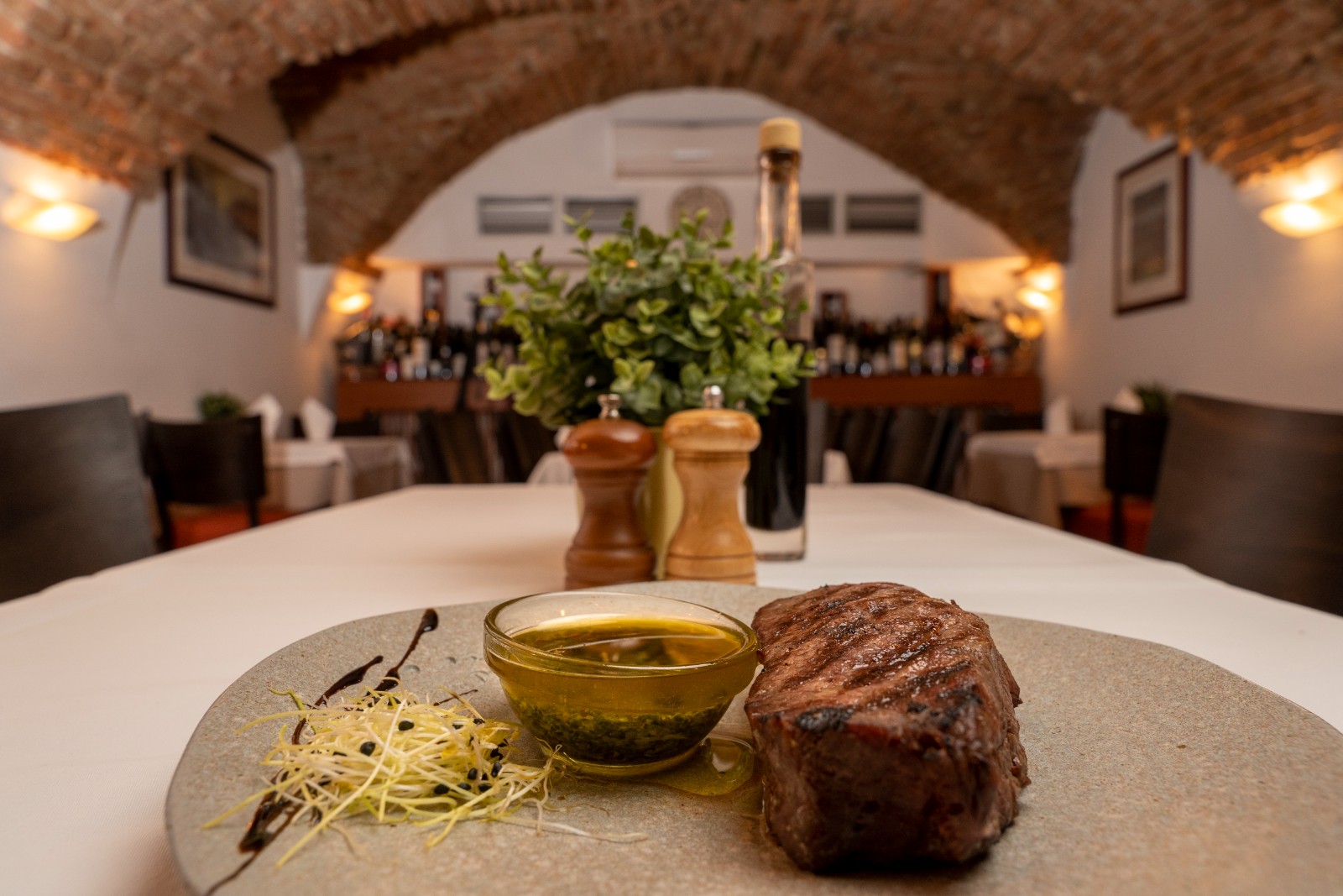 steak with prune sauce on the side at lanterna na dolcu croatian restaurant in zagreb