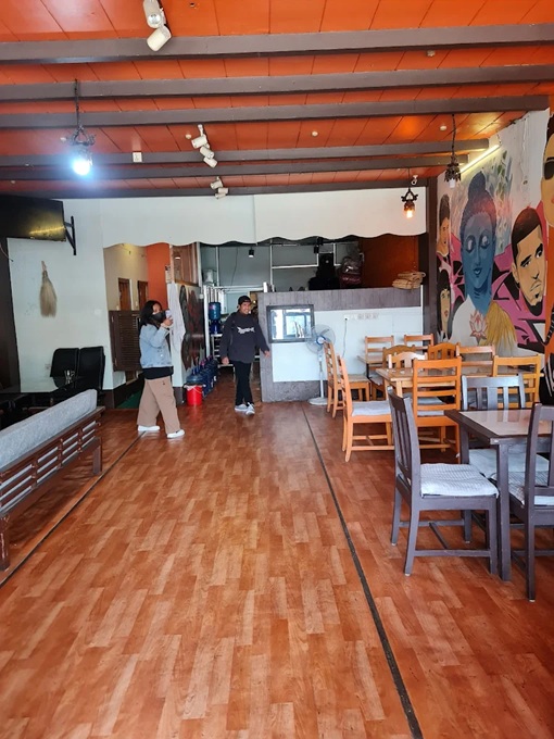 Interior of a restaurant in Pokhara with wooden tables and chairs