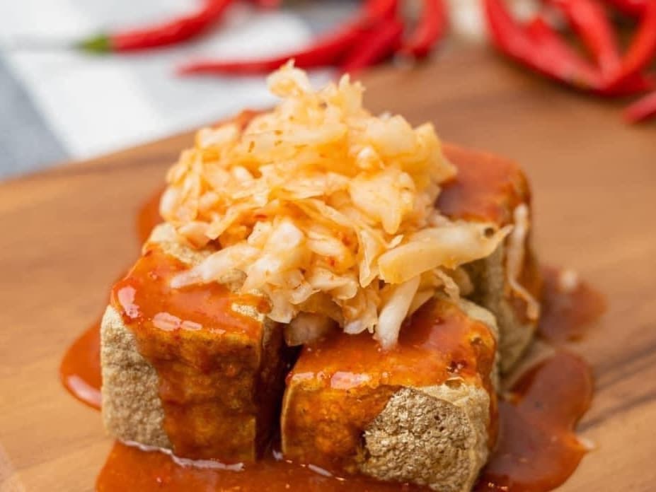 This street food is often topped with sauces and other toppings