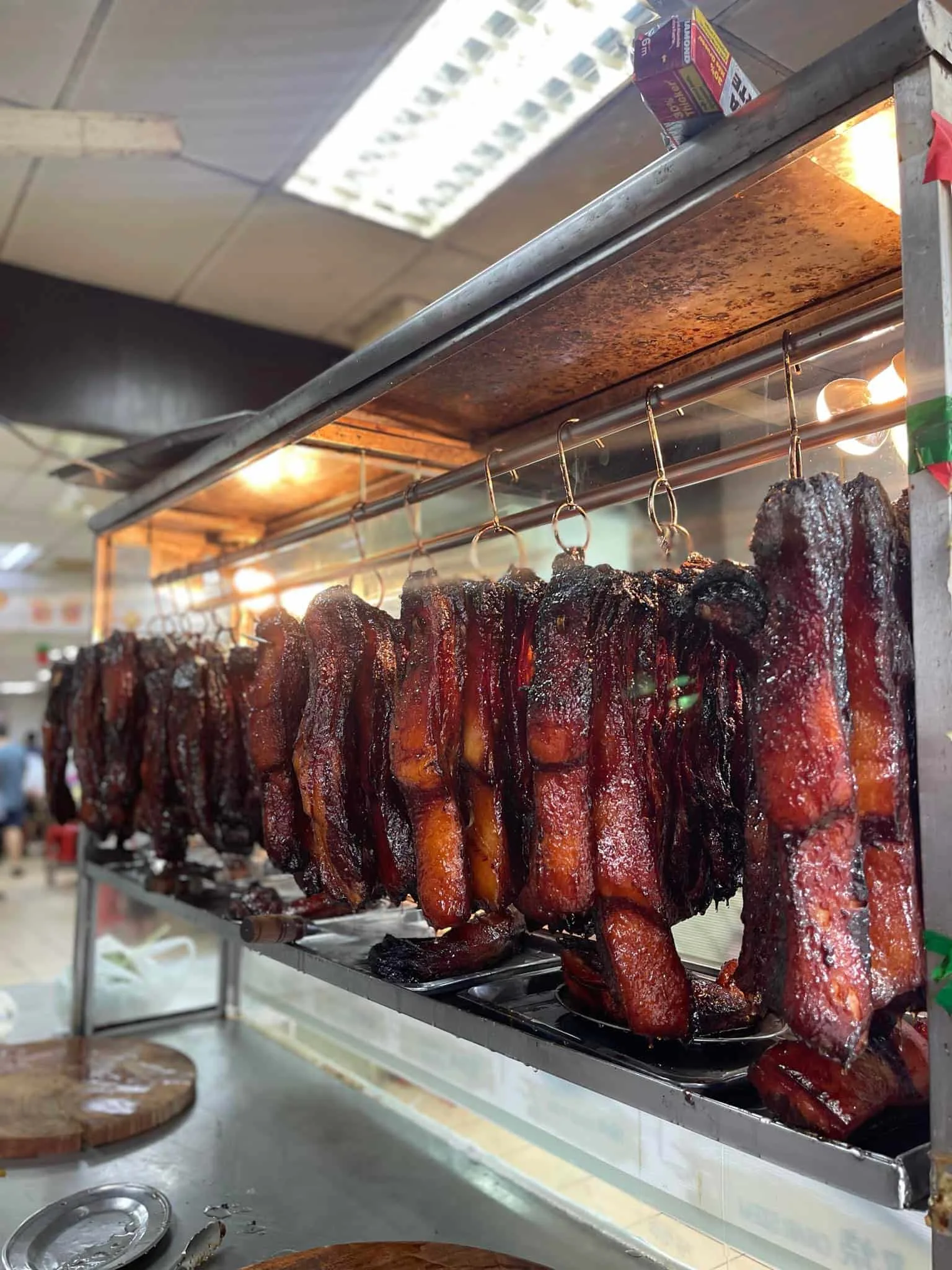 The sticky barbequed pork hanging up after they are cooked