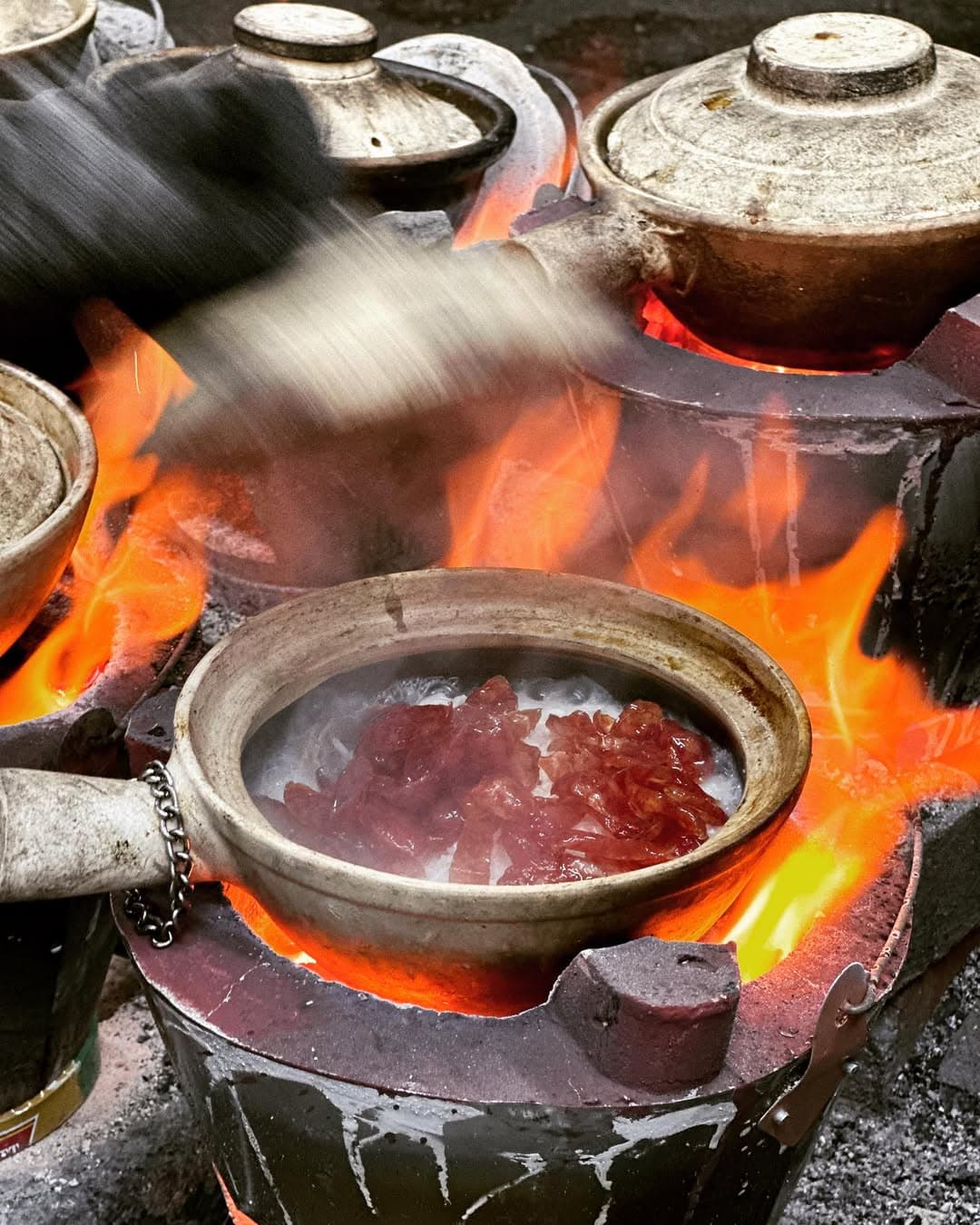 A meat version of this clay pot dish, cooking over flames