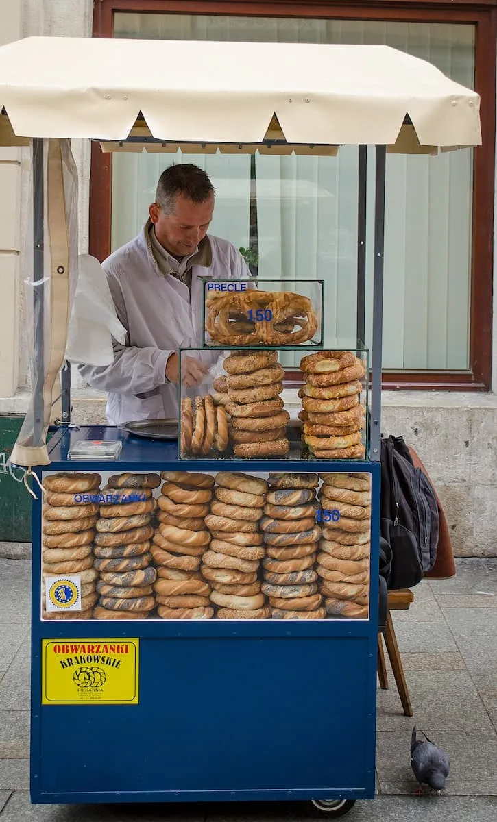 a blue cart with a white roof serving obwarzanek a polish street food in krakow poland