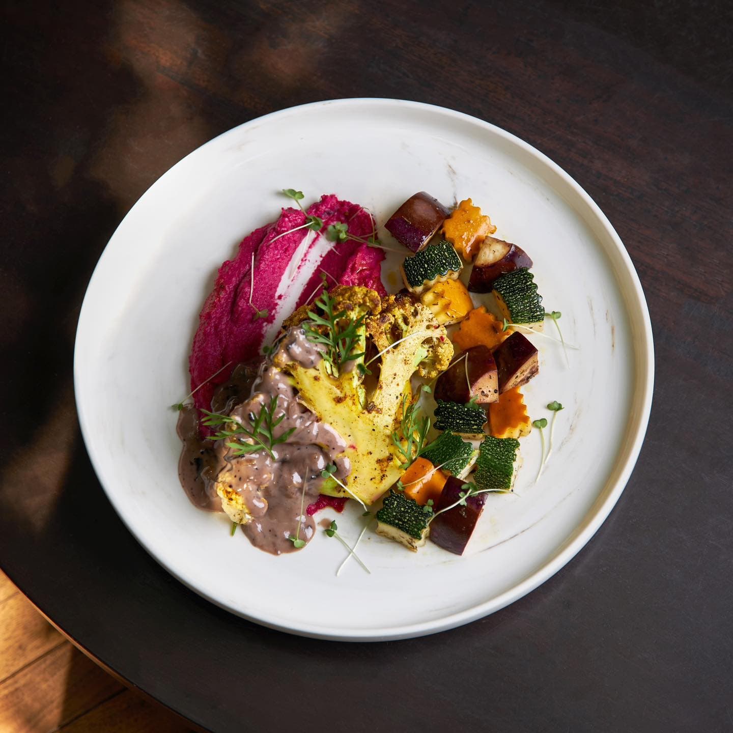 A vegetarain dish with cauliflower, abuergine and corguettes.