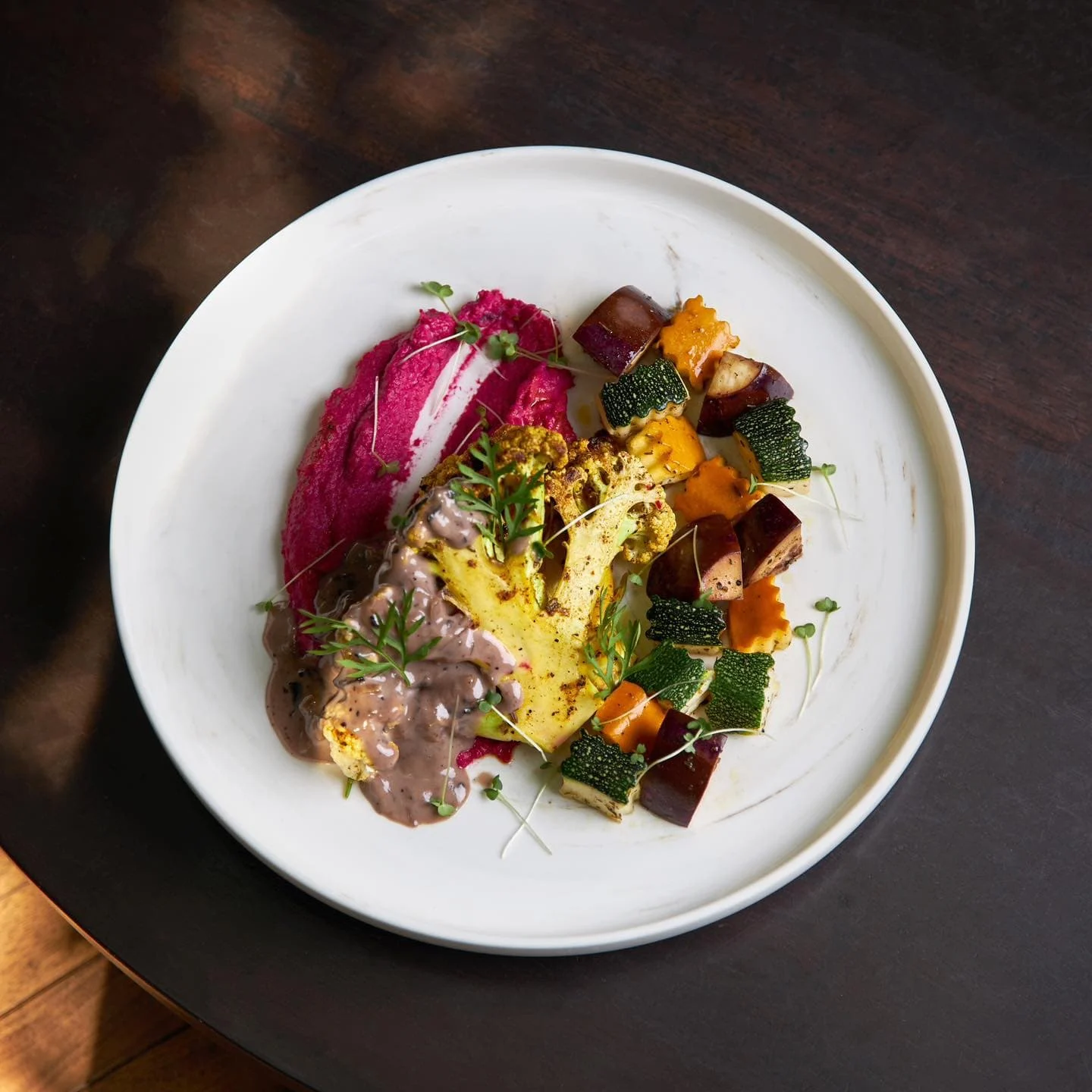 A vegetarain dish with cauliflower, abuergine and corguettes.