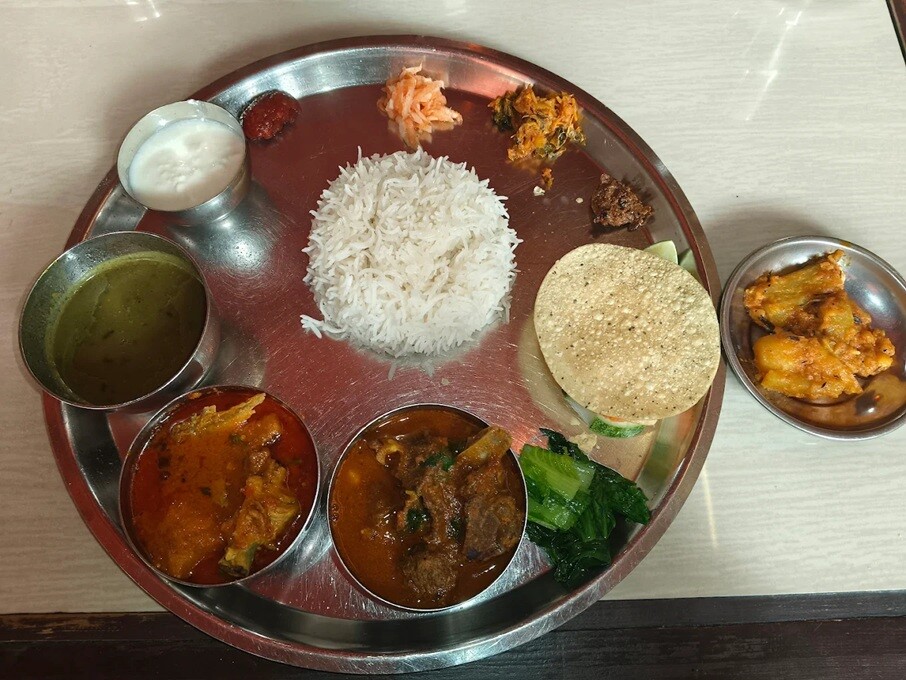 Nepalese thali meal set with assorted curries