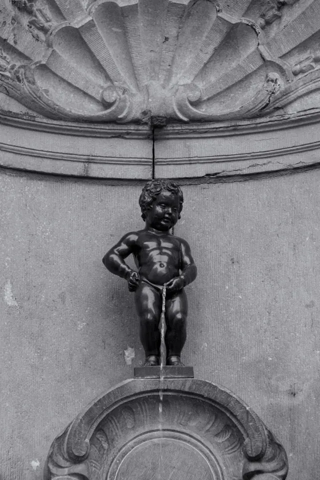 manneken pis is a small bronze fountain statue of a small boy urinating in brussels belgium