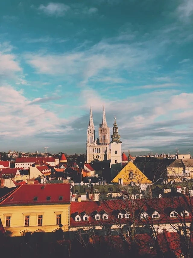 buildings with red roof tops in the lower town of zagreb croatia with a cathedral in the background