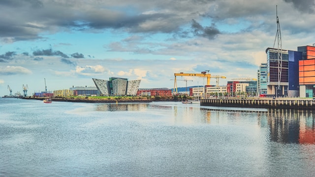 the modern building housing titanic belfast next to a yellow harland and wolff crane in belfast port northern ireland
