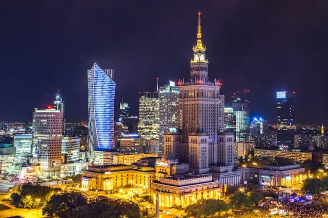 high rise buildings of the warsaw skyline illuminated at night