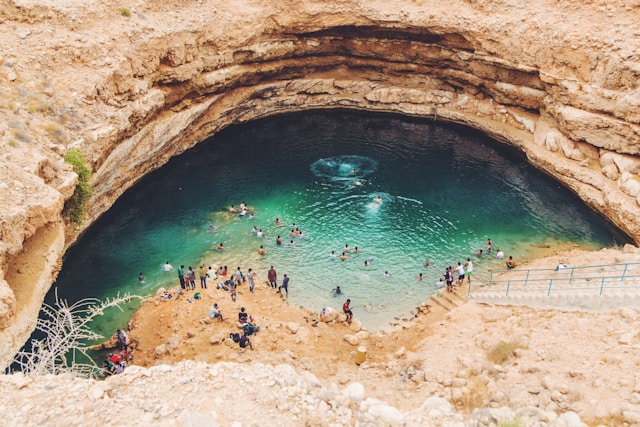 people swimming in bimmah sinkhole oman