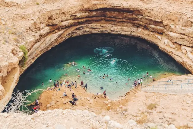 people swimming in bimmah sinkhole oman