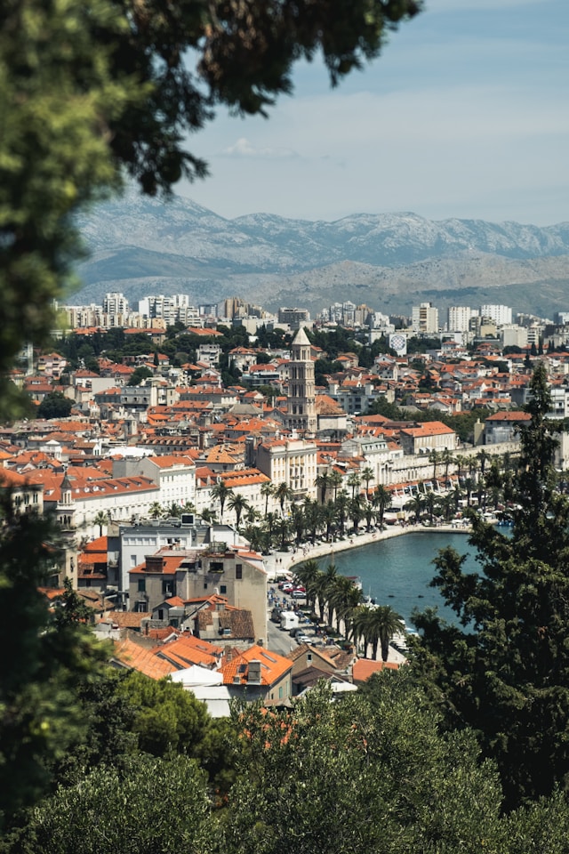 the baroque buildings of split old town in croatia with the bell tower in the background and the adriatic sea in the foreground