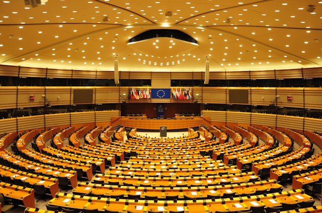 an auditorium with seating and the EU flag at the european parliament in brussels belgium