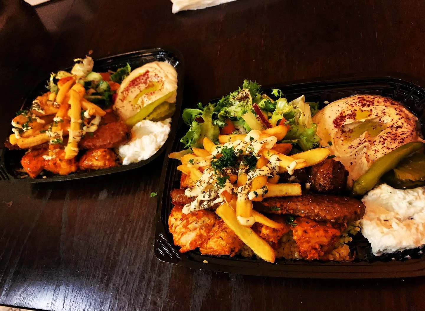 a lebanese mixed grill in a black plastic container from libanezza lebanese restaurant in antwerp belgium