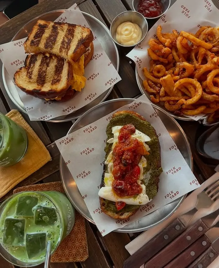 Onion rings with basil pesto, mozzarella, and cherry tomatoes sandwich