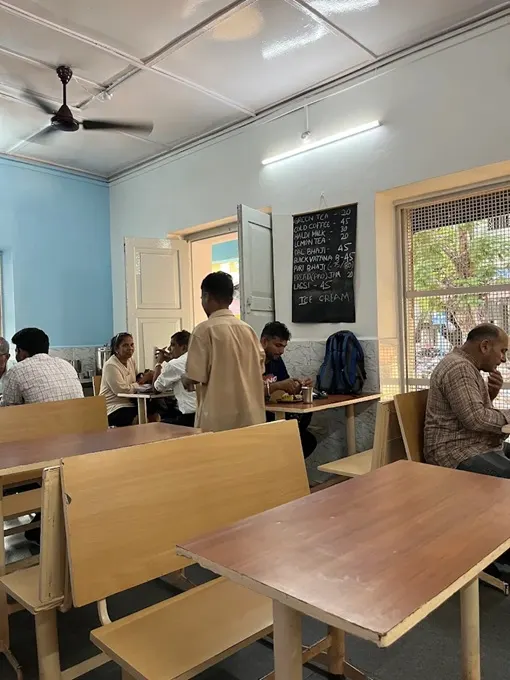 Wooden tables and seats in Goa's Cafe Aram