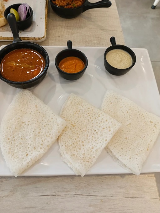 A platter of traditional Goan pancakes with chutneys