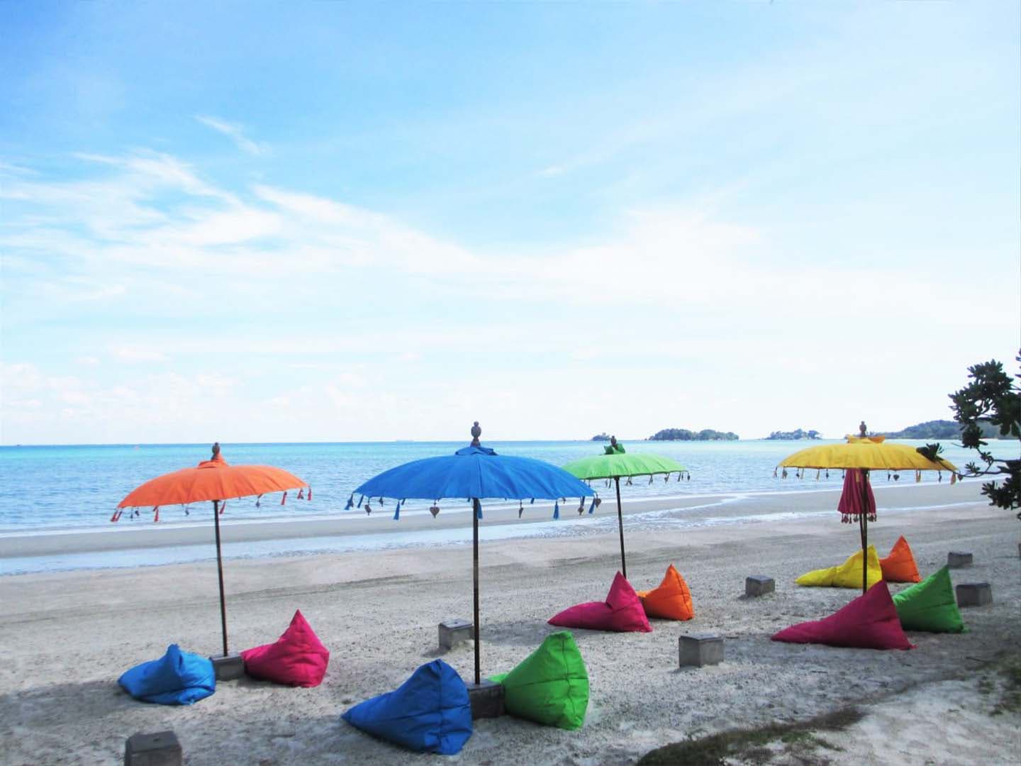 Bali's iconic beach umbrellas and colorful beanbags