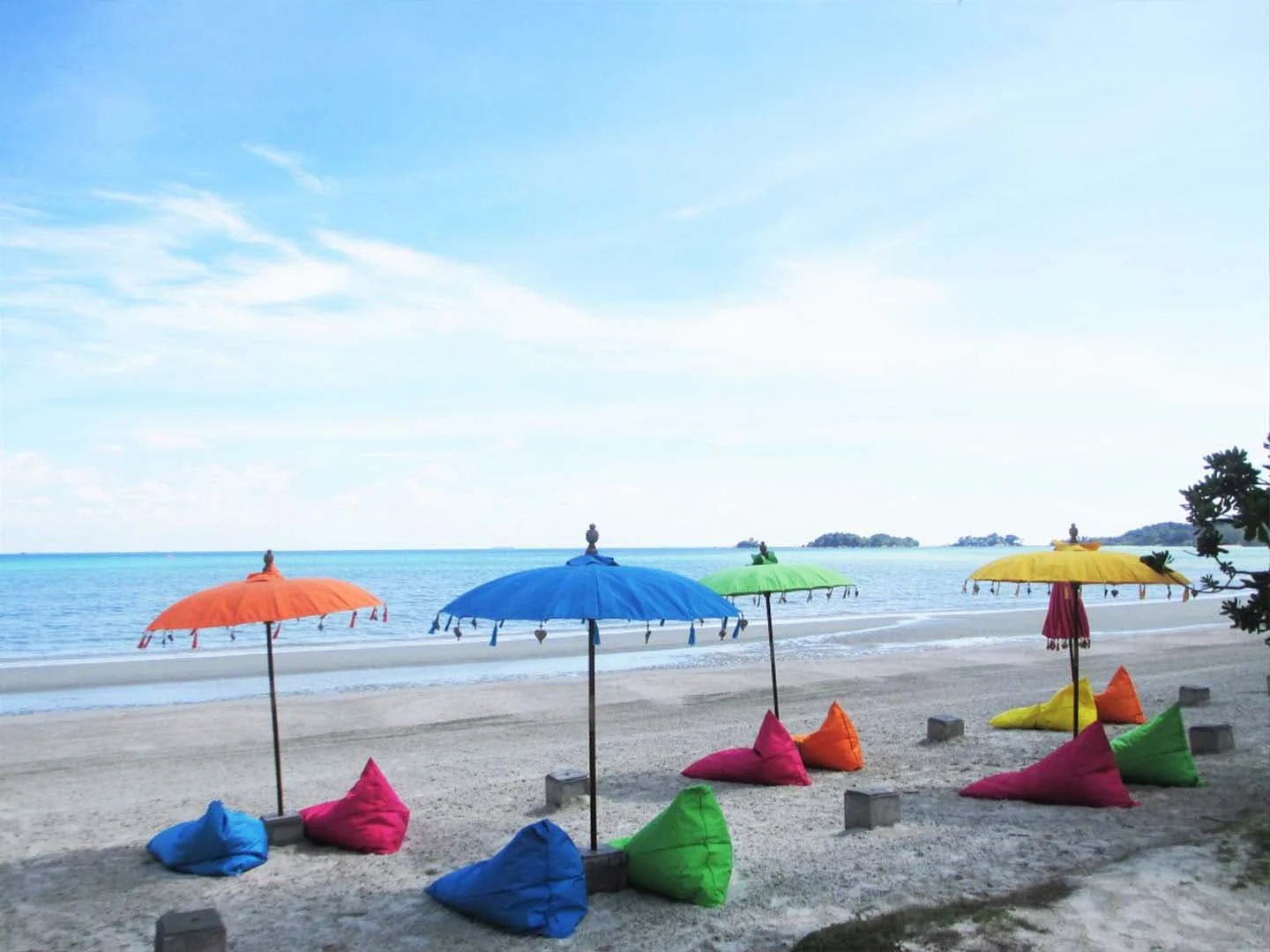 Bali's iconic beach umbrellas and colorful beanbags