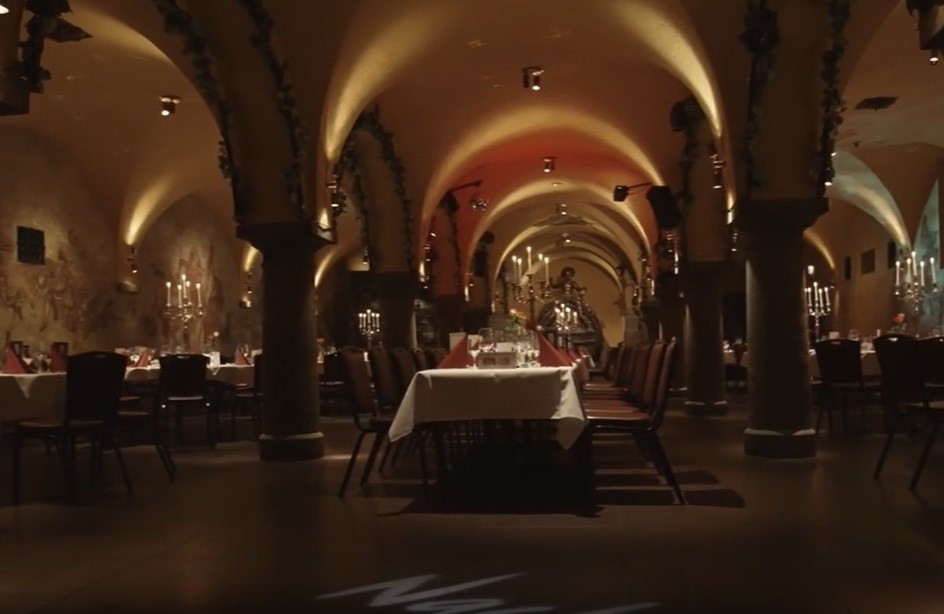 A restaurant table atmospherically lit, under a vaulted ceiling