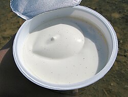 a tub of skyr yoghurt from iceland with the foil lid pulled back