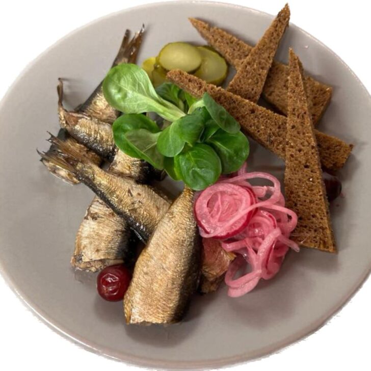 a grey plate topped with herring and rye bread from province restaurant in riga old town latvia
