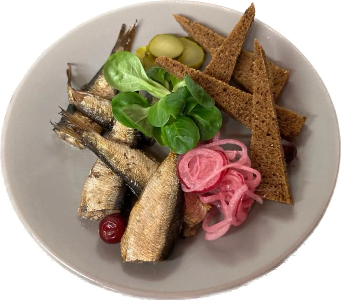 a grey plate topped with herring and rye bread from province restaurant in riga old town latvia