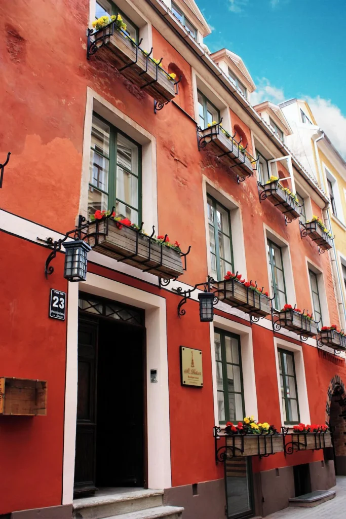 a red building with a black door is riga hotel in riga old town latvia
