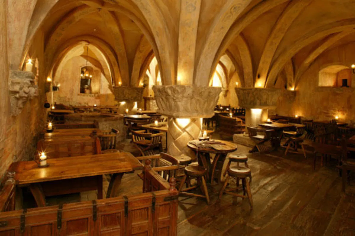tables and chairs in the medieval dining hall at rozengrals restaurant in riga latvia