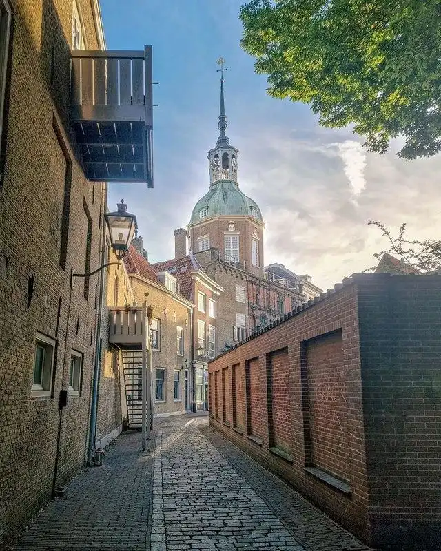 A church seen behind other buildings in Dordrecht