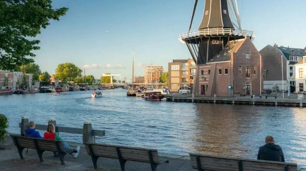 A windmill behind a river