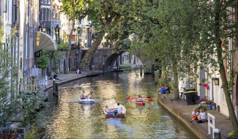 A canal in Utrecht with people cayaking on it
