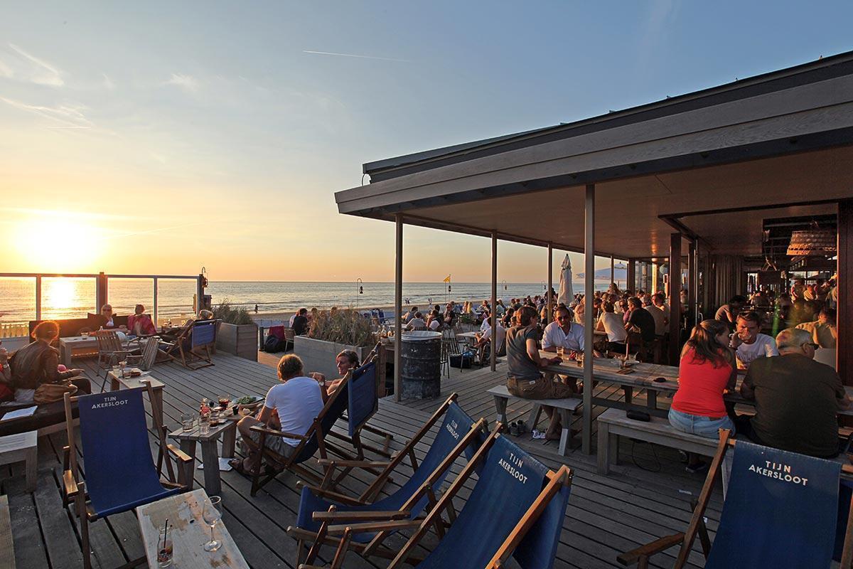 People sitting on a terrace by the sea