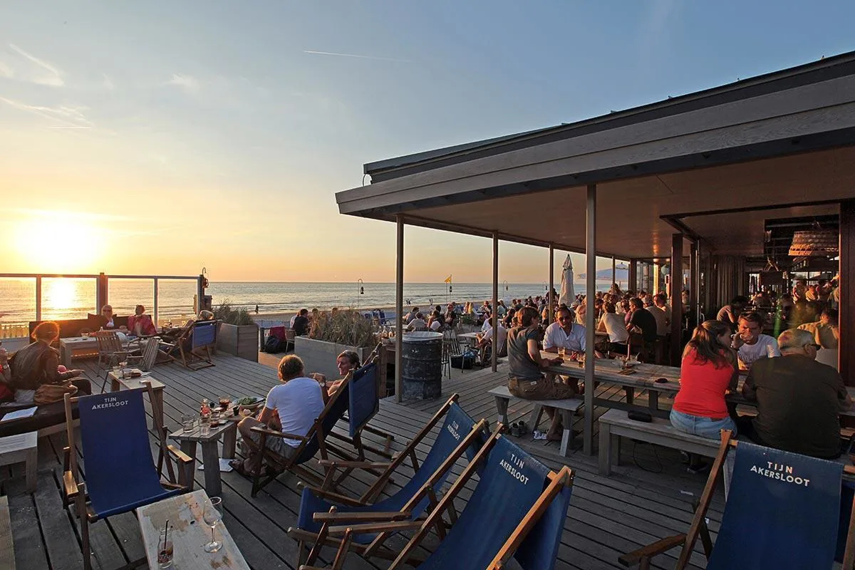 People sitting on a terrace by the sea