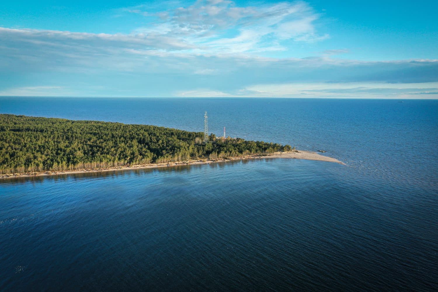 a sand spit extends beyond forests at cape kolka in latvia