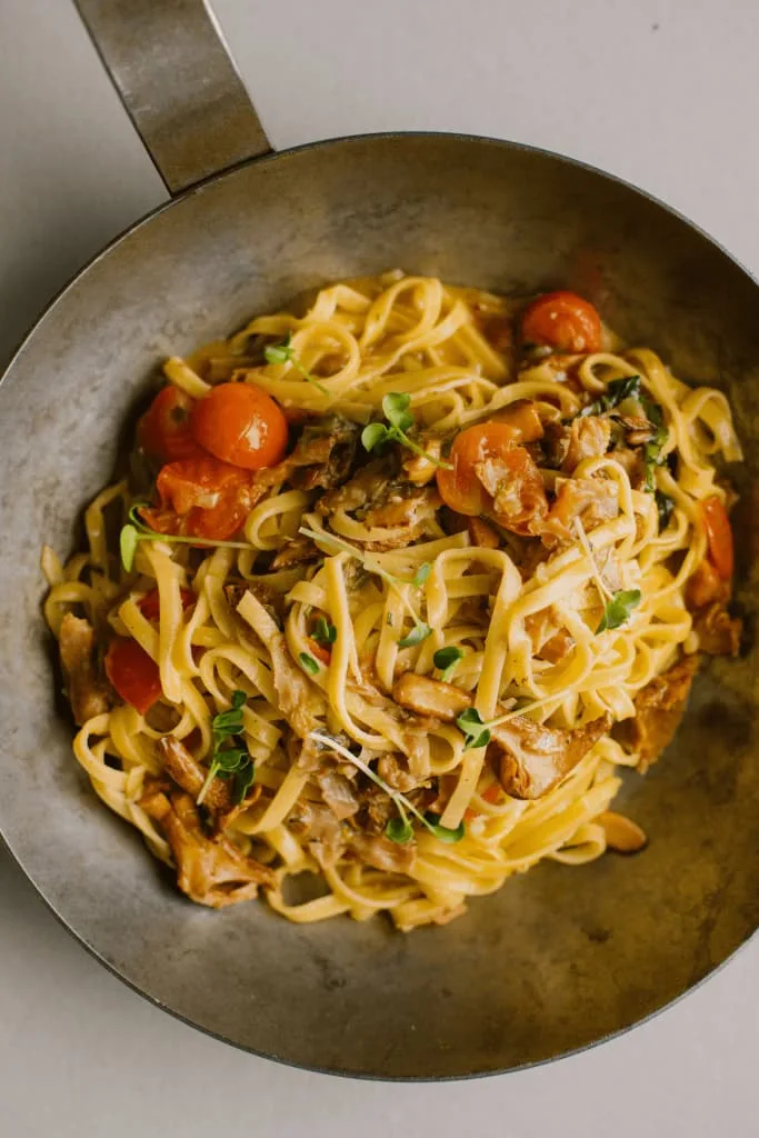 a bowl of pasta with cuttlefish and sundried tomatoes from comunale caffe e cucina in belgrade serbia