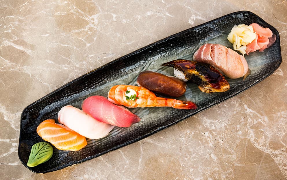 a black rectangular plate containing aburi sushi from ebisu japanese restaurant in the square nine hotel belgrade serbia