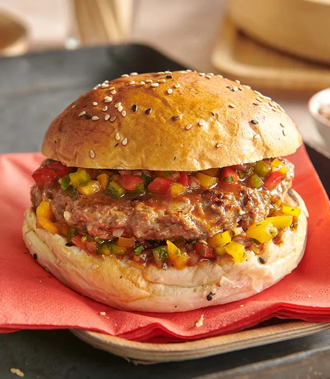 pljeskavica is a serbian hamburger served here in a traditional burger bun