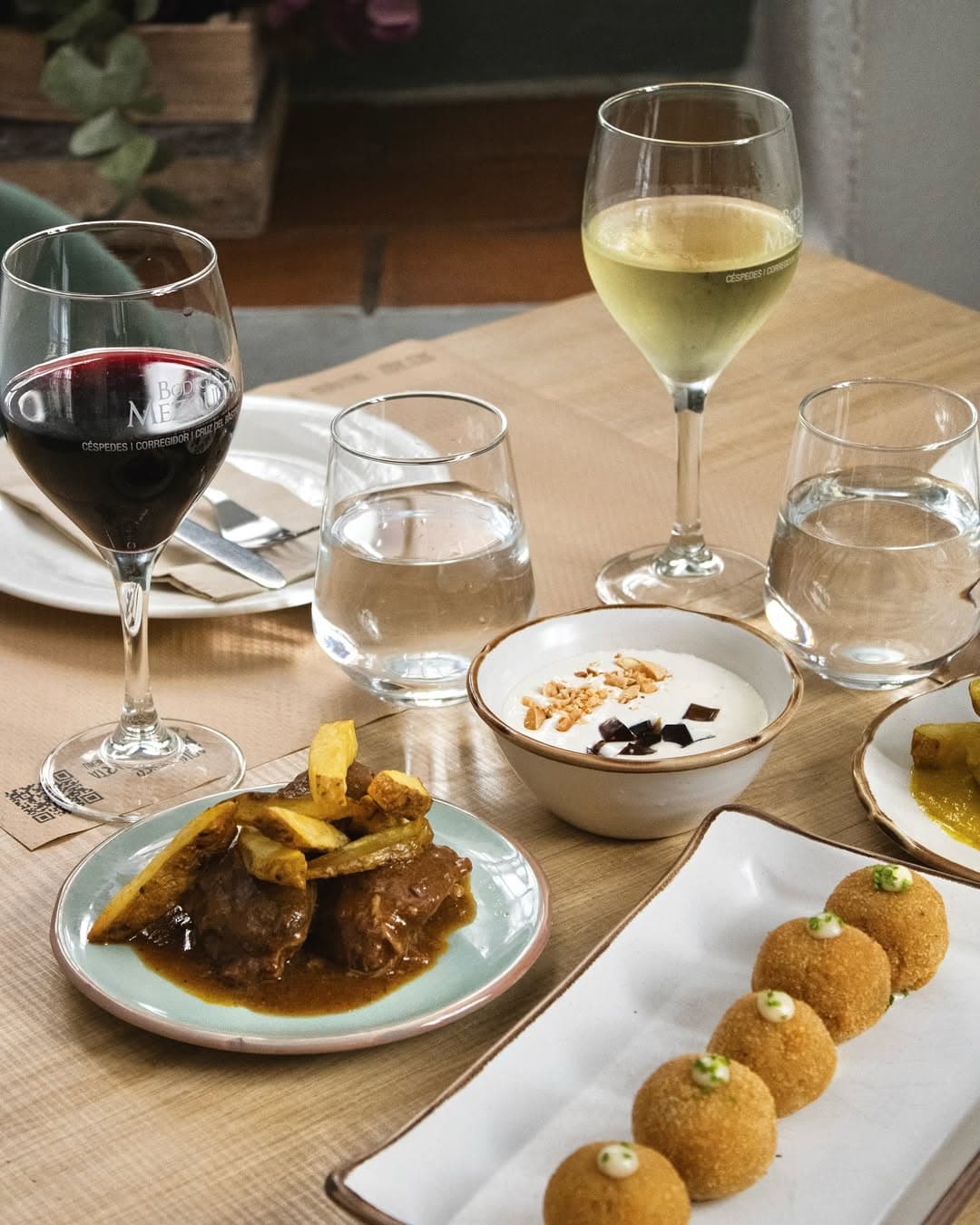 Spanish croquettes with meat stew, red and white local wine