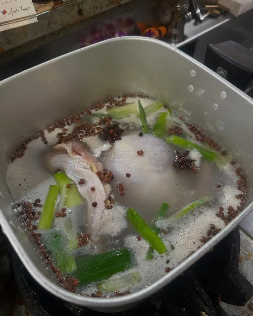Salted chicken on the boil with spices