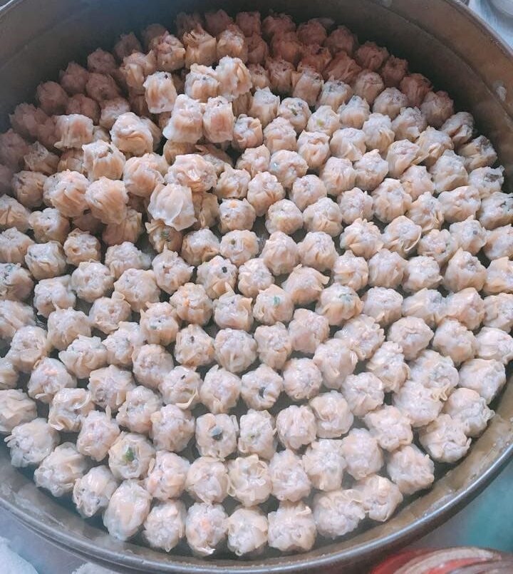 Siu miu pork dim sum are steamed in a massive pot