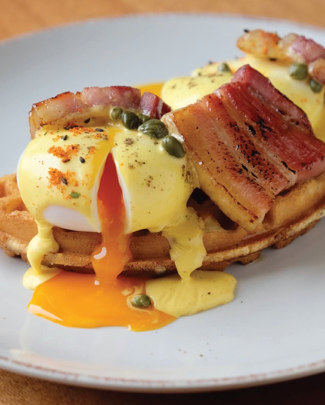 Poached eggs with bacon on a waffle