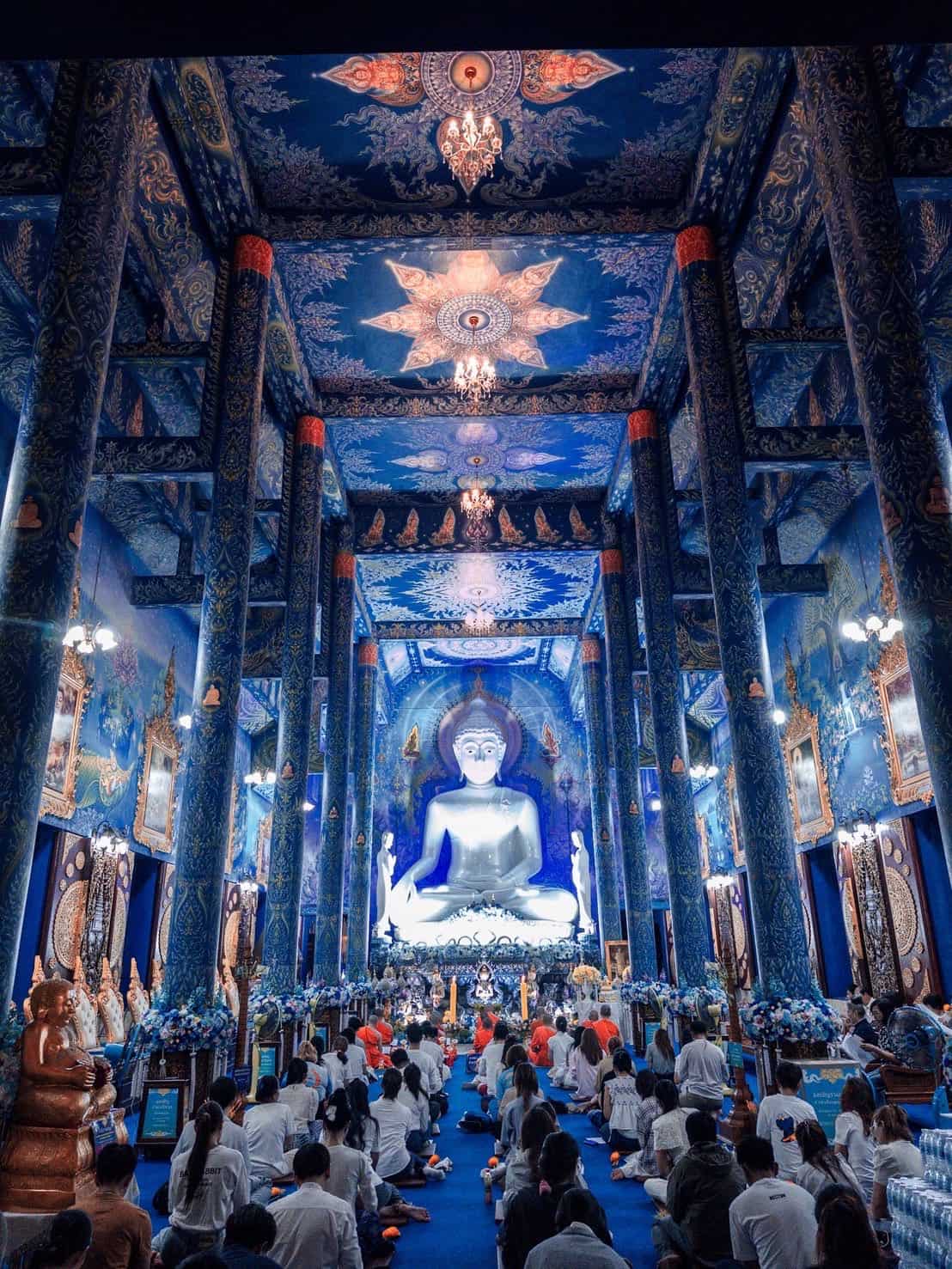 Interiors / buddha / worshippers at Wat Rong Suea Ten