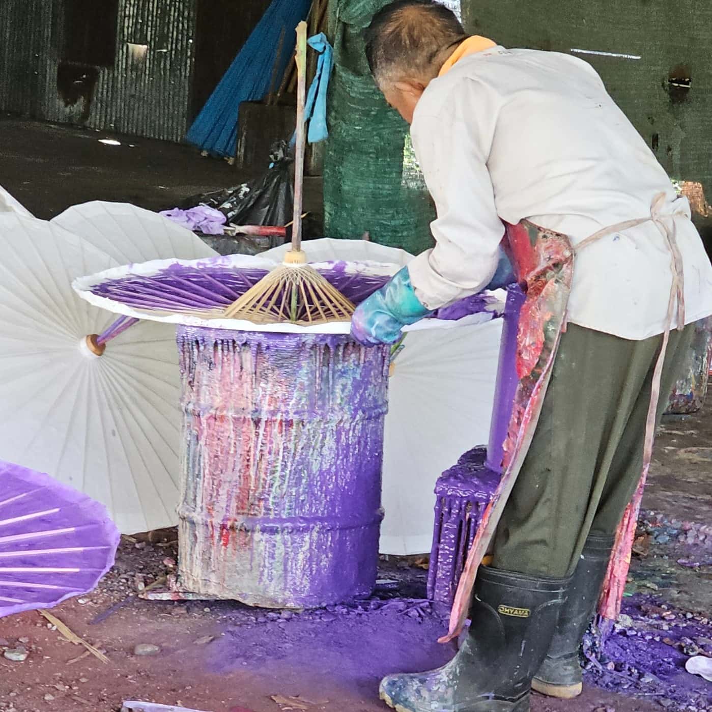 Artists at work dyeing bamboo umbrellas at Bo Sang Umbrella Village
