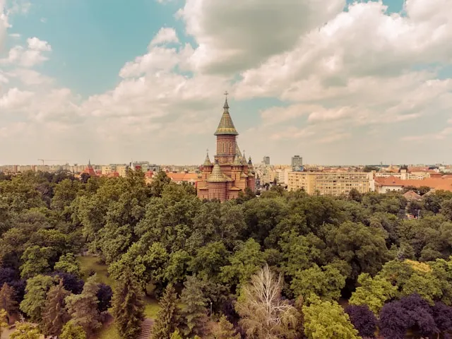 the metropolitan cathedral of timisoara romania behind trees