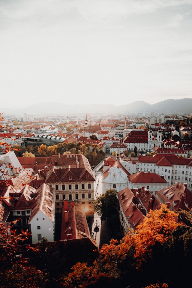 red rooftops and white buildings under cloud in graz austria