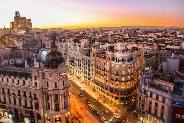 sunset over historic stone buildings in madrid spain the starting point of an epic 2 week europe by train itinerary