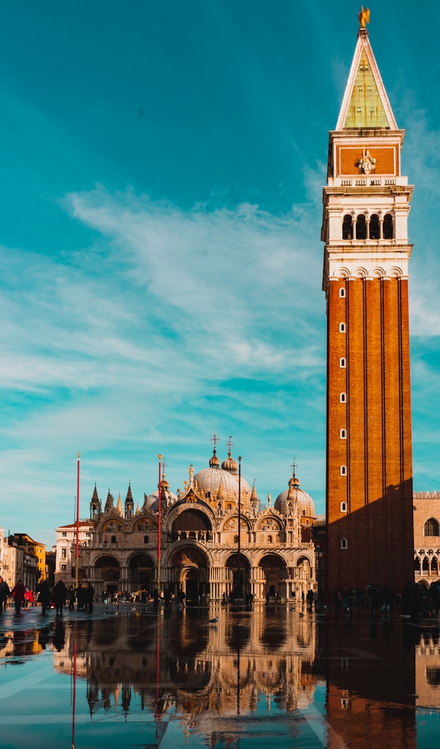 basilica san marco with it red brick clocktower overlooking a canal on piazza san marco venice italy