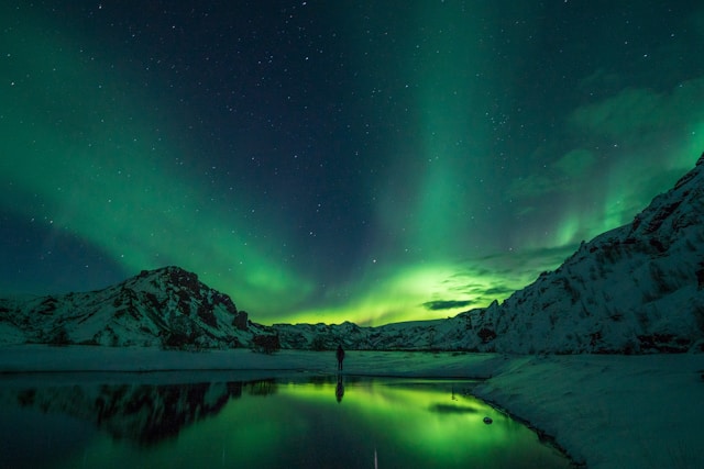 the aurora borealis northern lights over a fjord in iceland